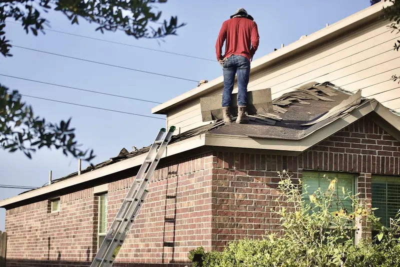 Professional roofer working on a residential roof in Rolling Hill Acres